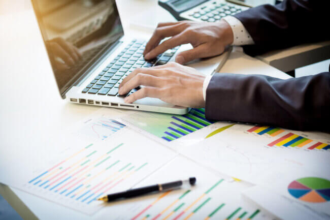 working process, business man typing on laptop.