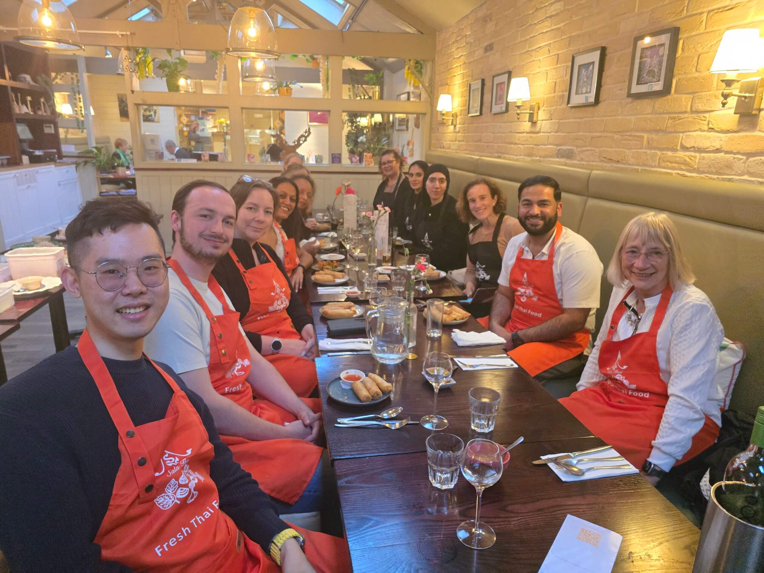 Colleagues learning to cook thai at Sala Thai.