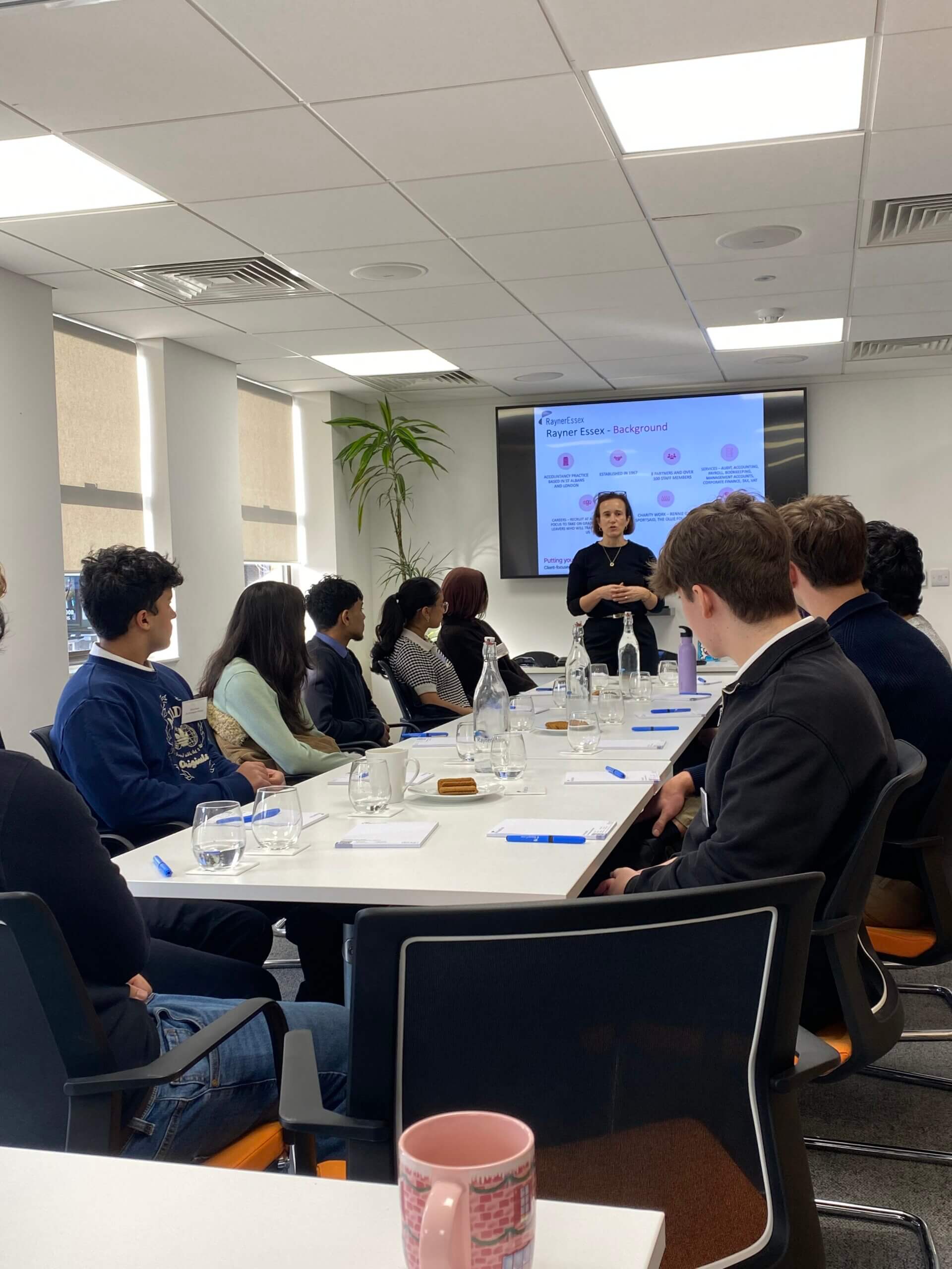 A group of work experience students in a meeting room being mentored by our team